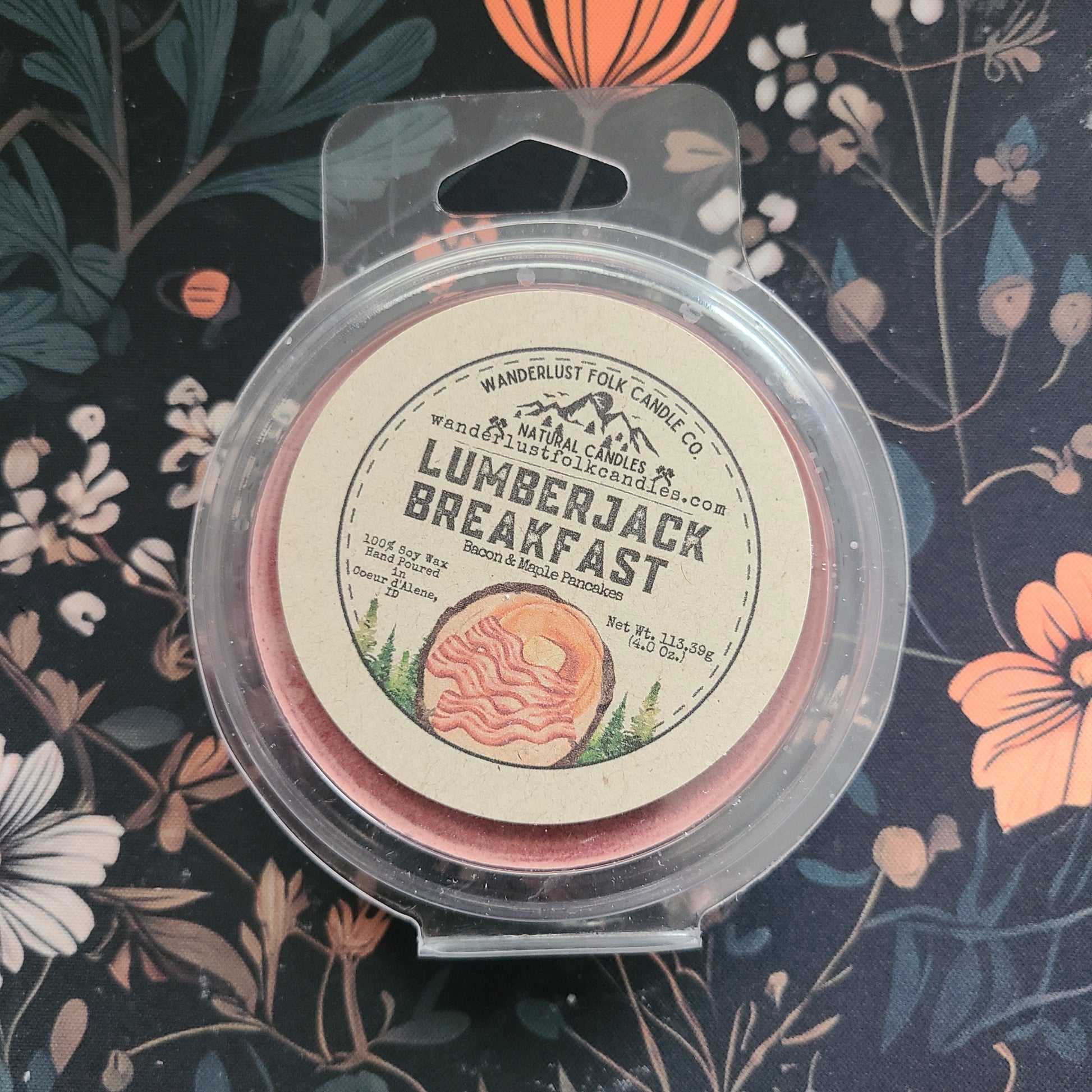 Wanderlust Road Lumberjack Breakfast candle in packaging on a floral background