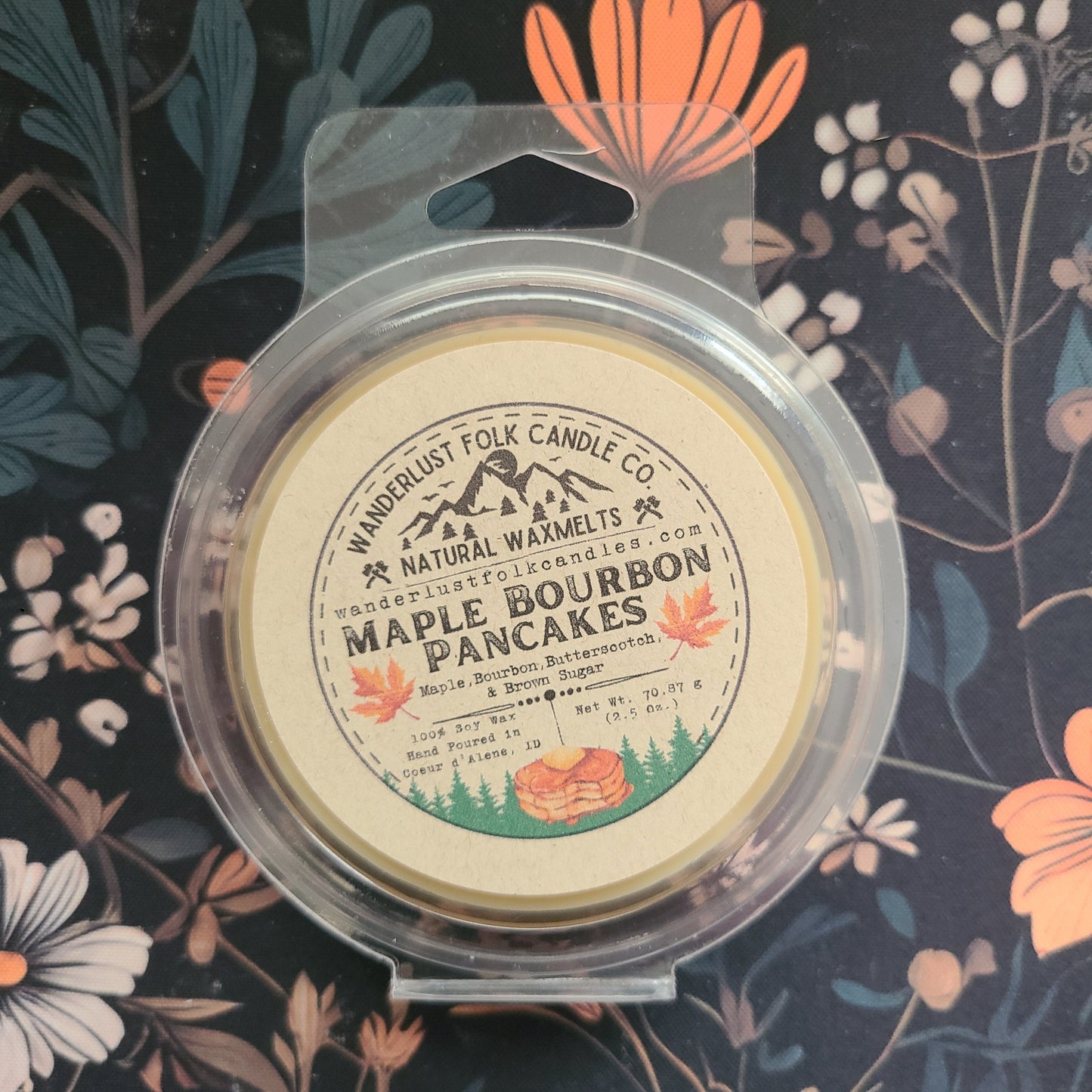 Maple Pancakes candle in packaging on a floral background